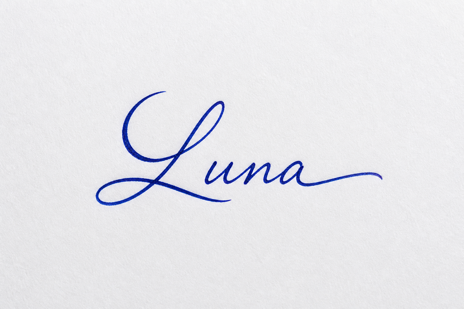 Royal-blue handwritten Luna signature with a capital L shaped like a subtle crescent moon